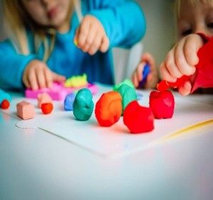 Image of a child playing with toys to develop fine motor skills